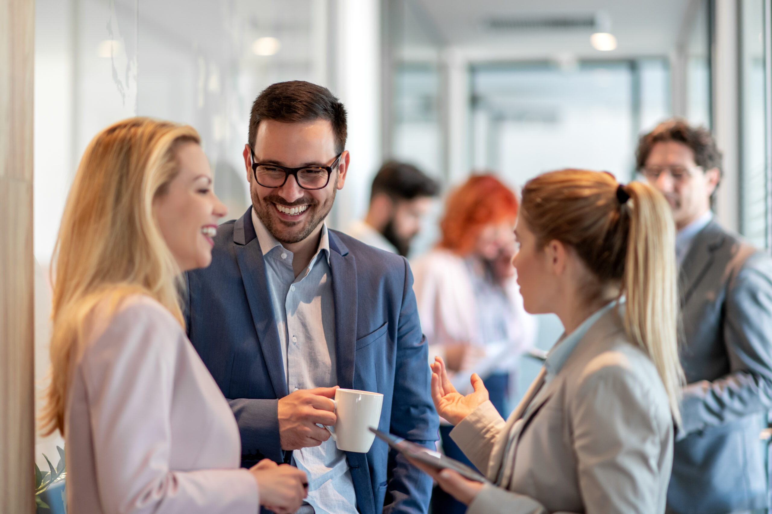 Business,people,chatting,in,office,lobby.,business,people,standing,and