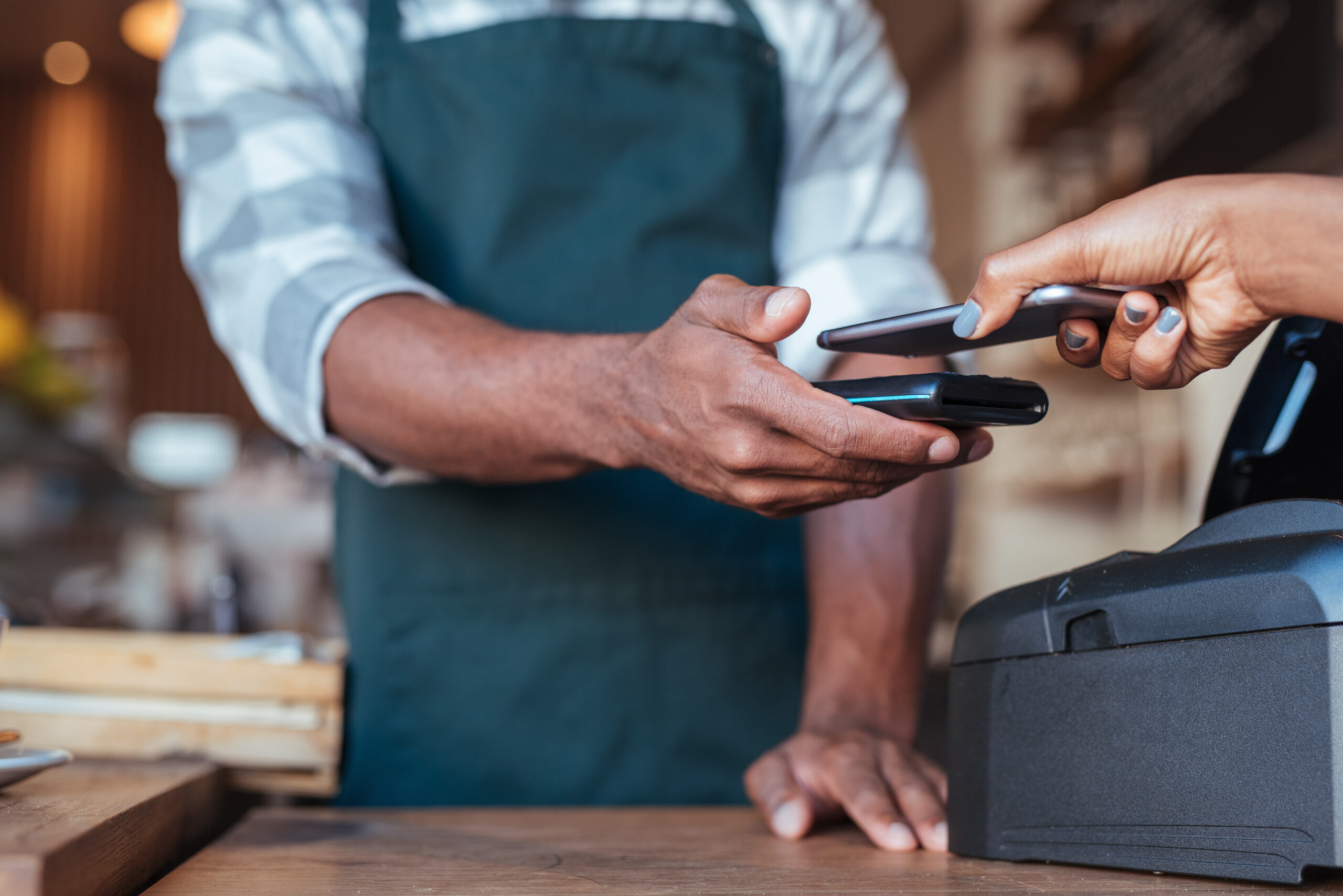 Closeup,of,a,customer,using,her,smartphone,and,nfs,technology