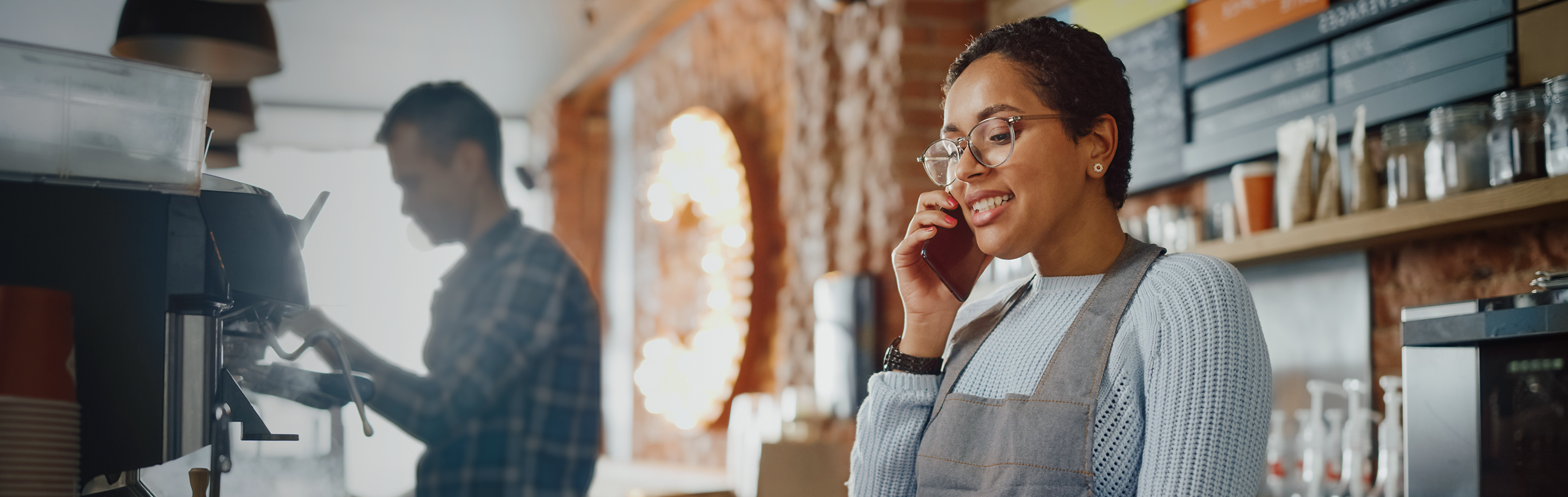 Appstar login page hero | Woman on the phone in a retail store